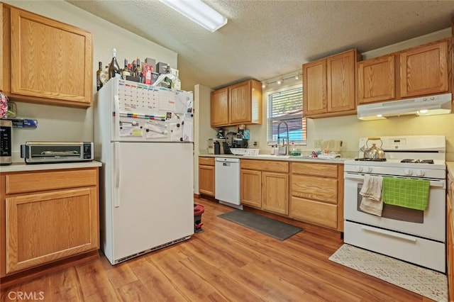22292 N Tuolumne Rd, Twain Harte, CA 95383 - kitchen featuring under cabinet range hood, a toaster, light wood-style floors, white appliances, and a sink