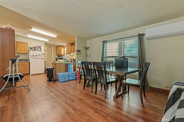 22292 N Tuolumne Rd, Twain Harte, CA 95383 - dining room with a textured ceiling, an AC wall unit, and wood finished floors