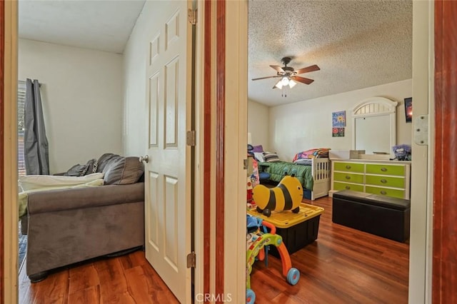 22292 N Tuolumne Rd, Twain Harte, CA 95383 - bedroom featuring a textured ceiling, ceiling fan, and dark wood-style flooring