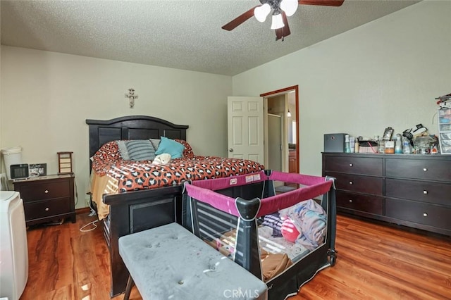 22292 N Tuolumne Rd, Twain Harte, CA 95383 - bedroom with ceiling fan, a textured ceiling, and wood finished floors