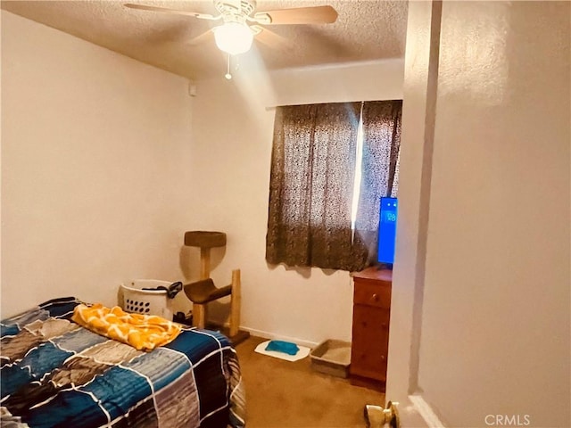 carpeted bedroom with baseboards, a textured ceiling, and a ceiling fan