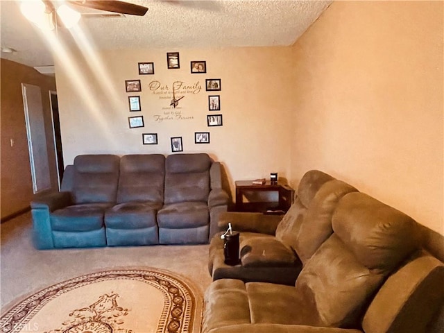 living room featuring carpet flooring, a textured ceiling, and ceiling fan