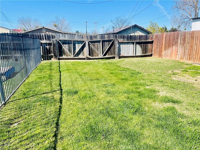 view of yard with a fenced backyard