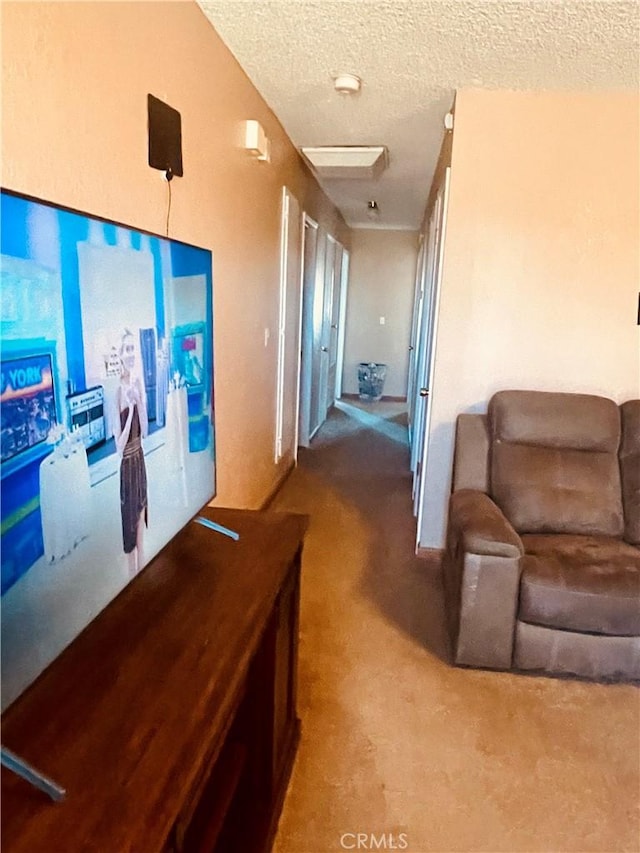 hall featuring a textured ceiling