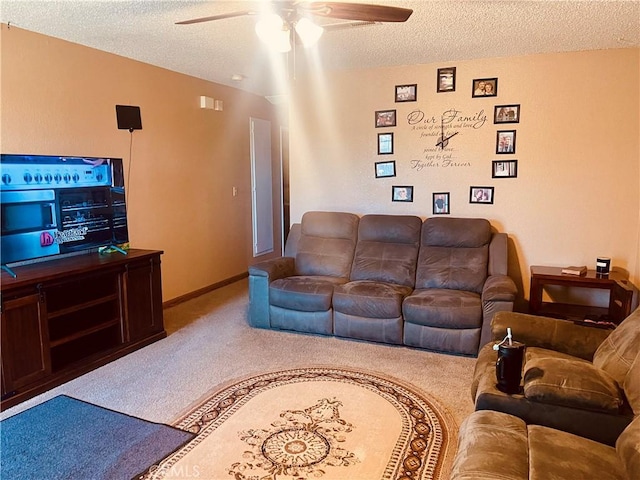 living area with carpet floors, a textured ceiling, and ceiling fan