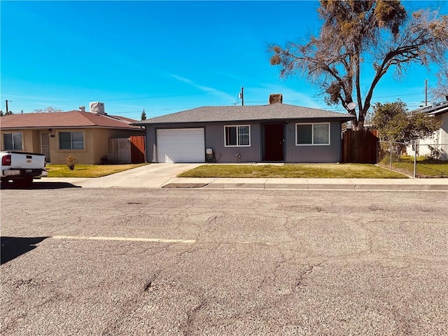 ranch-style house with fence, concrete driveway, a front yard, an attached garage, and a chimney