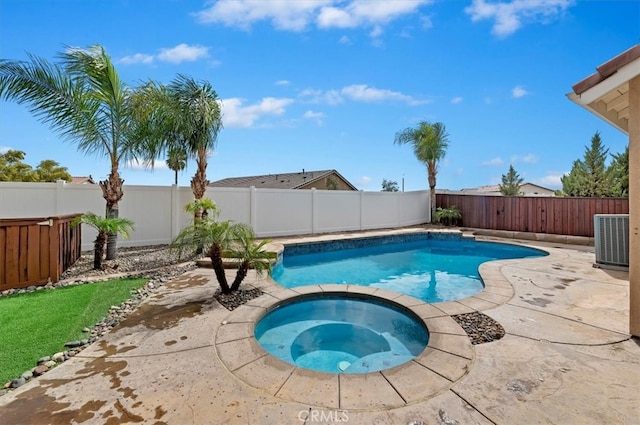 view of pool featuring central air condition unit, a patio, a fenced backyard, and a pool with connected hot tub