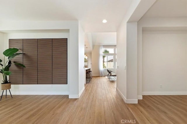 hall with recessed lighting, baseboards, and light wood-style floors