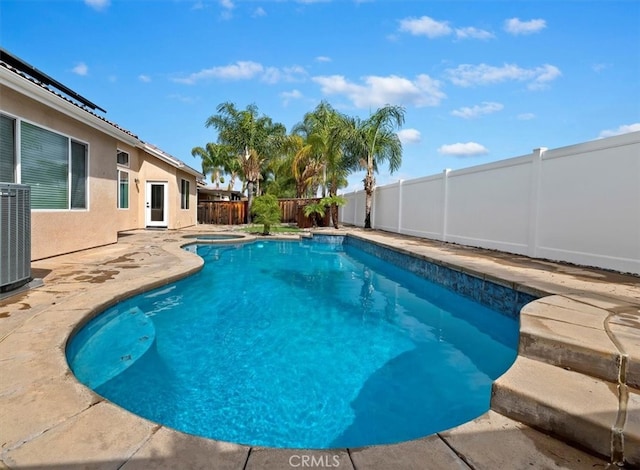 view of pool featuring central air condition unit, a fenced backyard, a patio area, a fenced in pool, and a hot tub