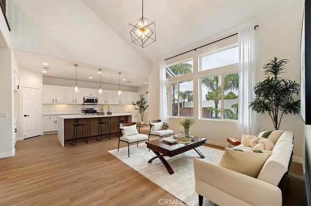 living room featuring recessed lighting, high vaulted ceiling, baseboards, and light wood-type flooring
