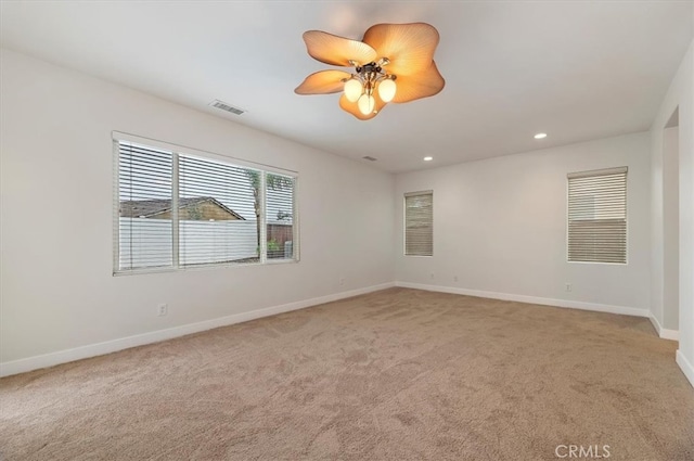 spare room featuring recessed lighting, visible vents, light colored carpet, and baseboards