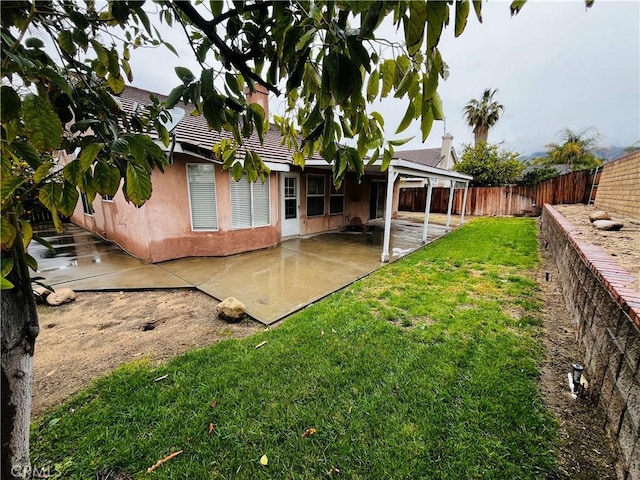 view of yard with a patio and a fenced backyard