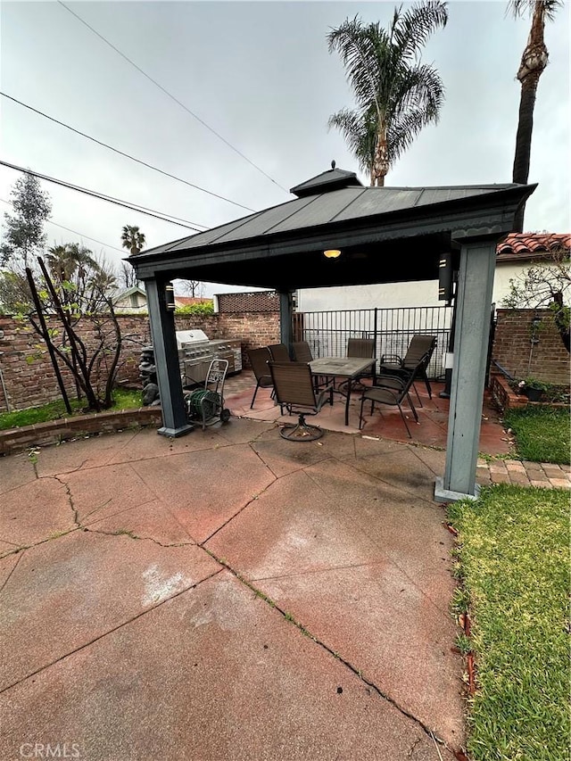 view of patio / terrace with a gazebo and fence