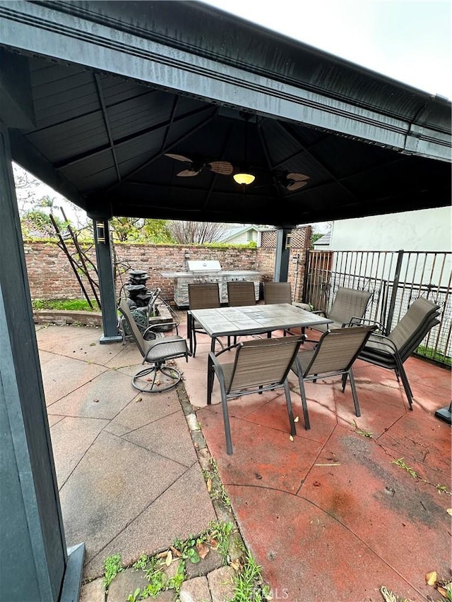 view of patio featuring outdoor dining space and a gazebo