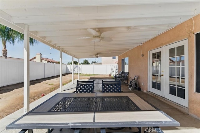 view of patio / terrace featuring an outdoor fire pit, a fenced backyard, french doors, and a ceiling fan