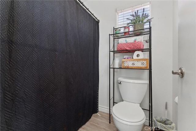 full bathroom with wood finished floors and toilet