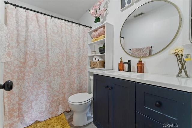 bathroom with visible vents, toilet, and vanity