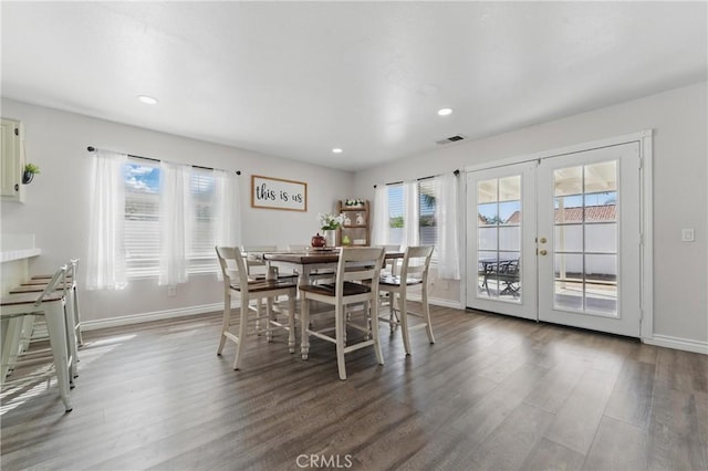 dining area featuring baseboards, visible vents, wood finished floors, and french doors