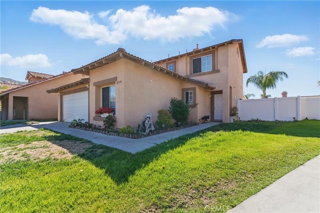 mediterranean / spanish-style house with a front yard, stucco siding, fence, and an attached garage