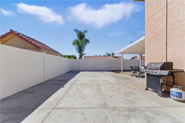 view of patio featuring a grill and a fenced backyard