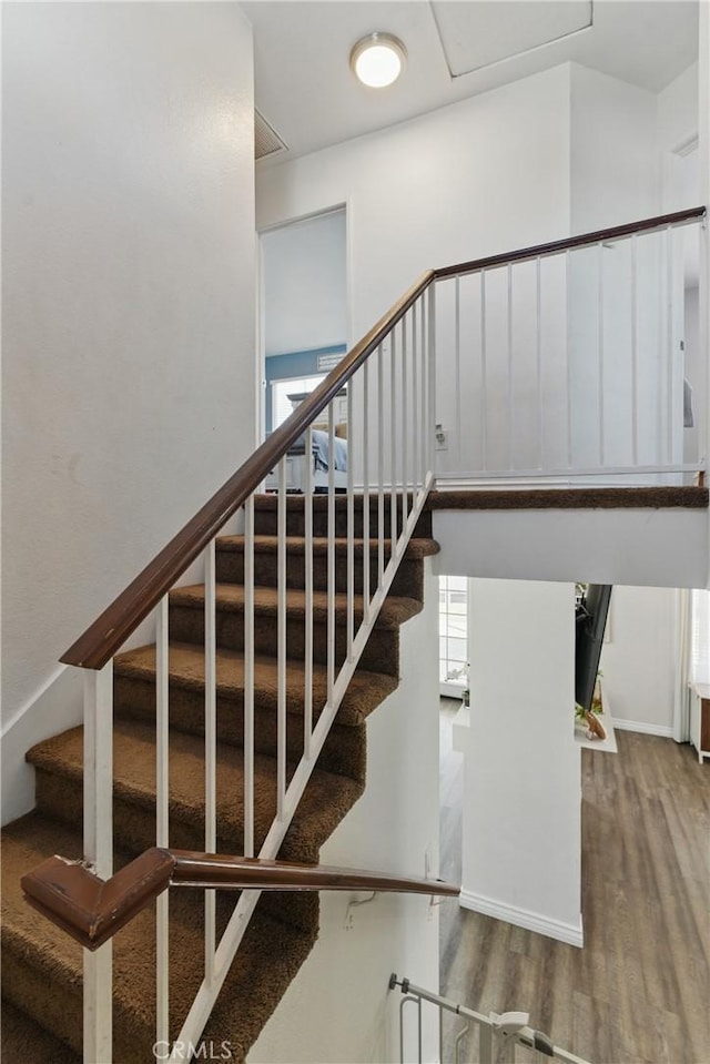 staircase featuring wood finished floors