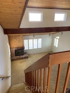 staircase featuring high vaulted ceiling, wood ceiling, and carpet