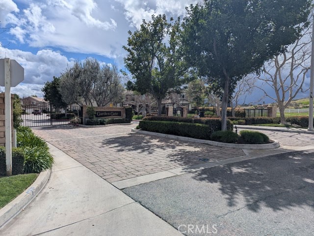9770 Winterberry Dr, Riverside, CA 92803 - view of road featuring traffic signs, a gate, and curbs