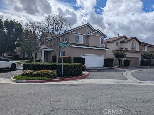 9770 Winterberry Dr, Riverside, CA 92803 - view of front of property featuring an attached garage, driveway, and stucco siding