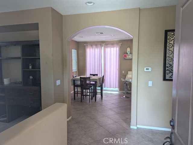 9770 Winterberry Dr, Riverside, CA 92803 - dining space with arched walkways, baseboards, tile patterned floors, and visible vents