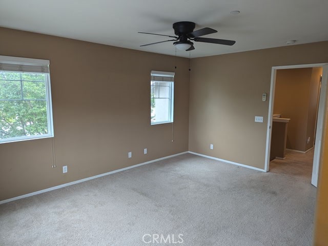 9770 Winterberry Dr, Riverside, CA 92803 - spare room featuring carpet flooring, ceiling fan, and a wealth of natural light