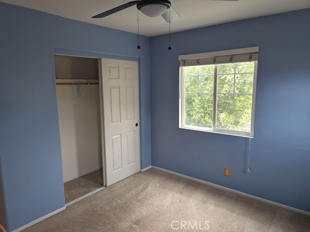 9770 Winterberry Dr, Riverside, CA 92803 - unfurnished bedroom with ceiling fan, baseboards, carpet, and a closet