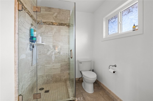 full bathroom featuring a shower stall, toilet, and baseboards