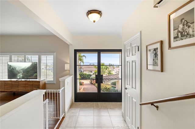 foyer with plenty of natural light, french doors, and light tile patterned floors