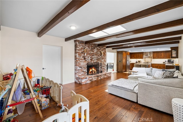 living room with beamed ceiling, dark wood-type flooring, and a fireplace