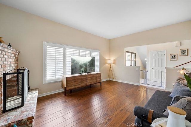 sitting room featuring baseboards, hardwood / wood-style floors, and a fireplace