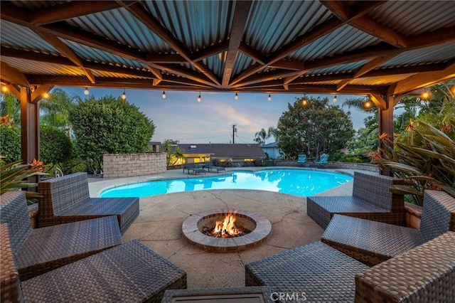 pool with a gazebo, a patio, and a fire pit