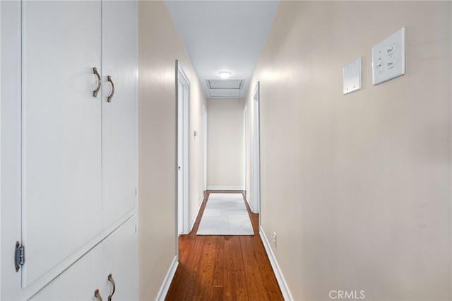 hallway with wood finished floors and baseboards