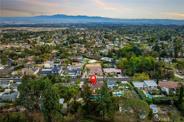 aerial view at dusk with a mountain view and a residential view