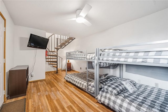 bedroom with light wood-style flooring and ceiling fan