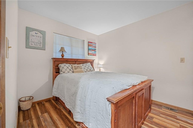 bedroom featuring visible vents, baseboards, and light wood-style floors