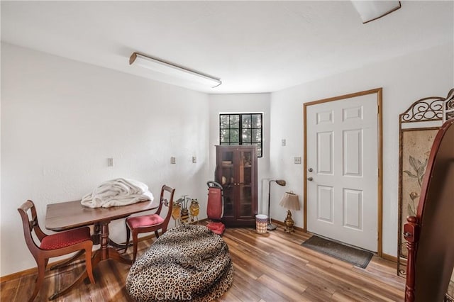 dining room featuring baseboards and wood finished floors