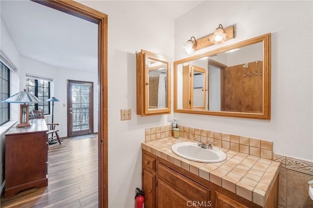 bathroom with wood finished floors and vanity