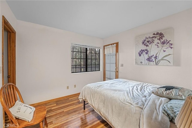 bedroom featuring baseboards and wood finished floors