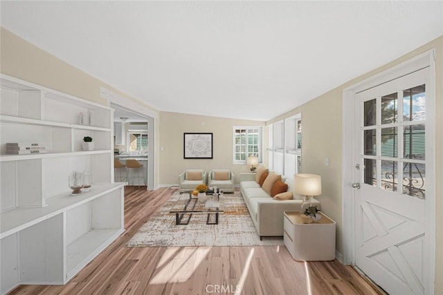 living room featuring baseboards and wood finished floors