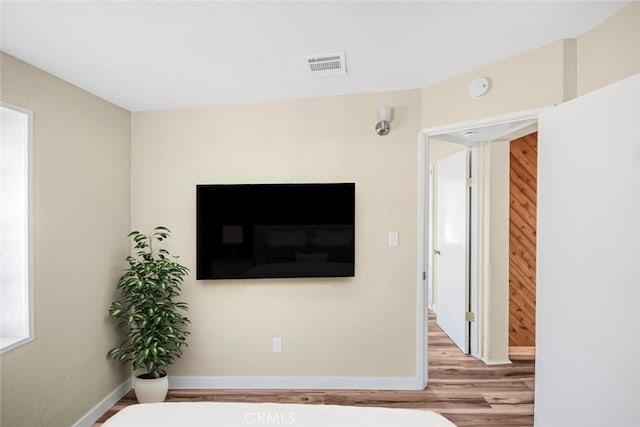 interior space featuring visible vents, baseboards, and wood finished floors