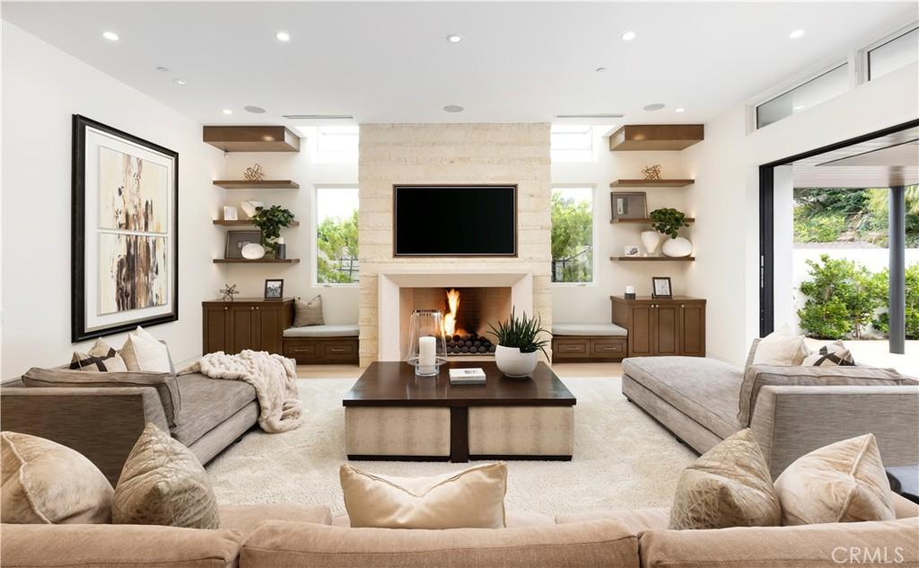 living room with recessed lighting and a large fireplace