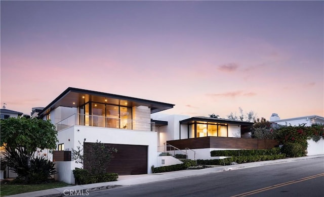 modern home with a balcony and a garage