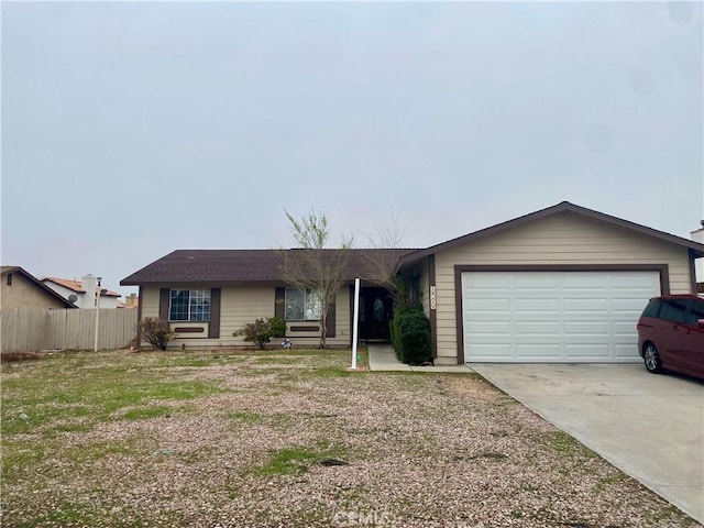 ranch-style home featuring fence, a garage, and driveway