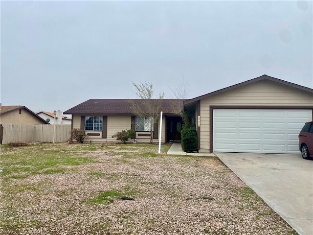 ranch-style home featuring concrete driveway, an attached garage, and fence