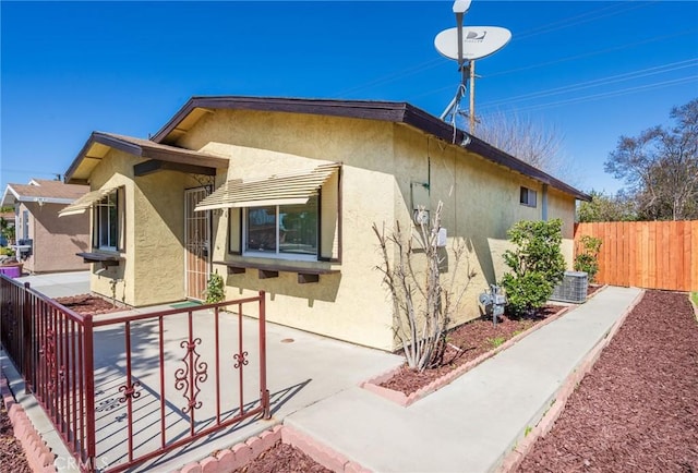 exterior space featuring stucco siding, a patio, and fence